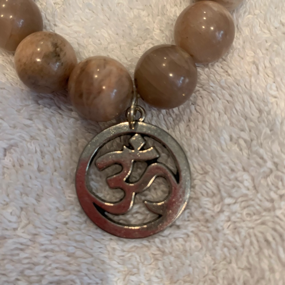 Tan agate beaded bracelet with Asian symbol charm